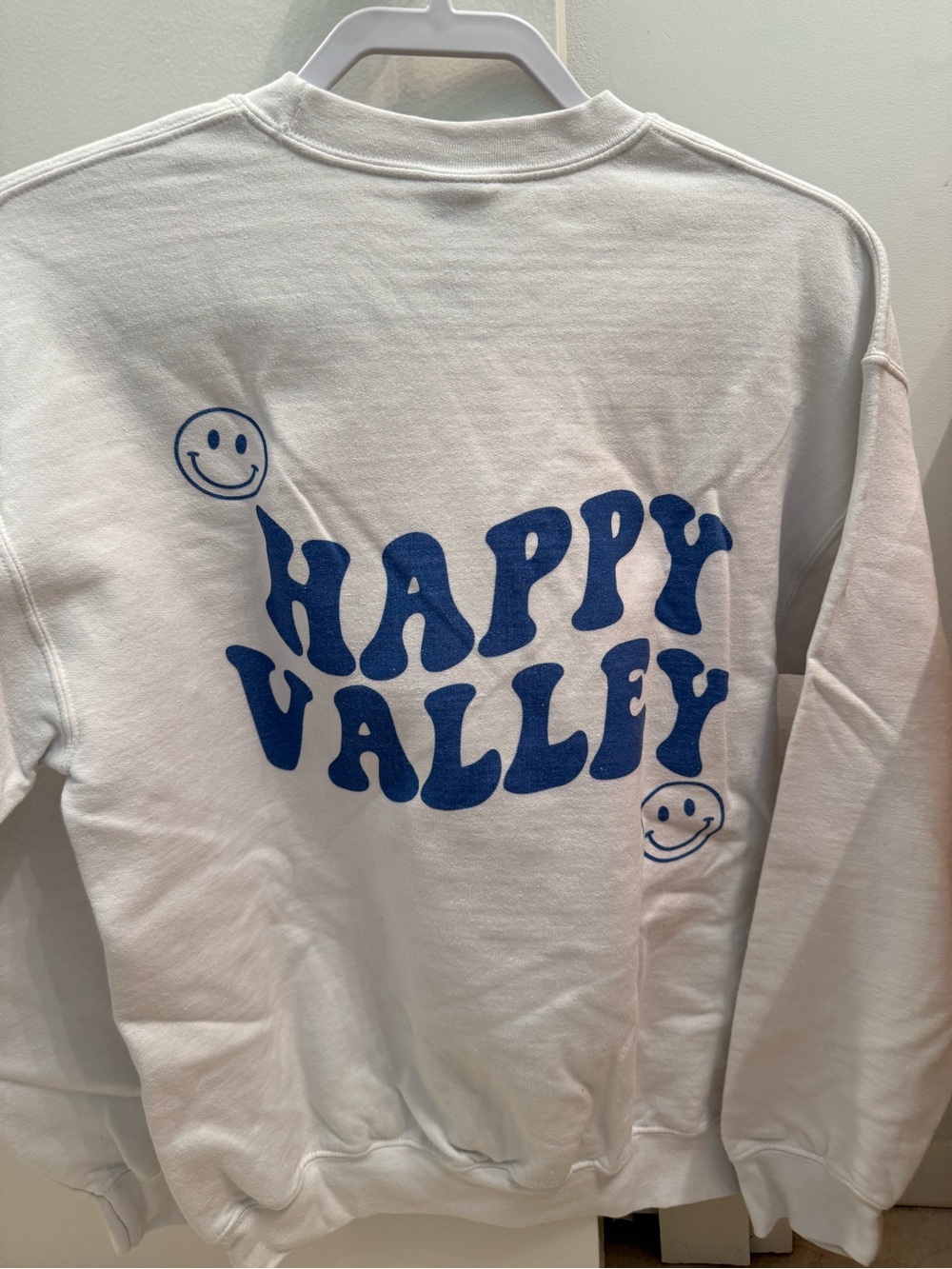 Happy Valley White Sweatshirt with Blue Graphic on the back